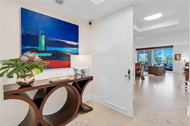 tiled home office with a raised ceiling