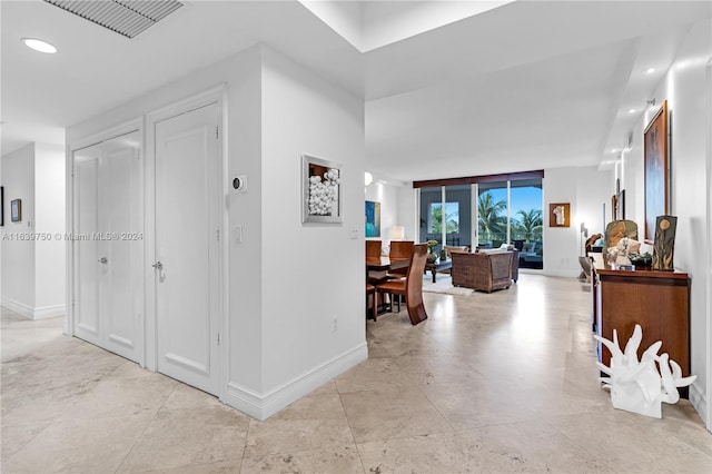 hall featuring light tile patterned floors