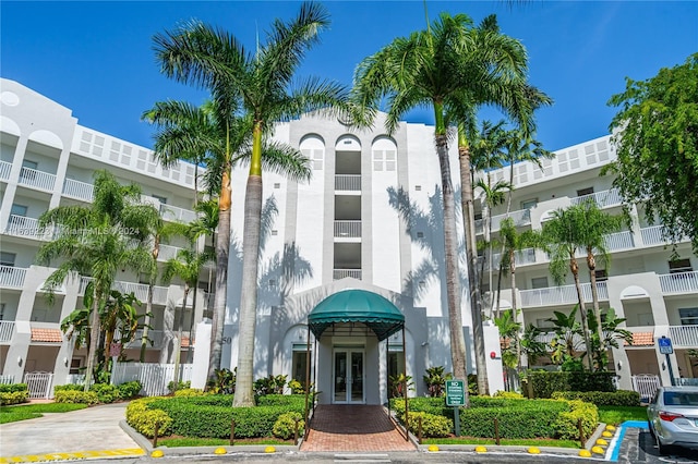 view of building exterior featuring uncovered parking