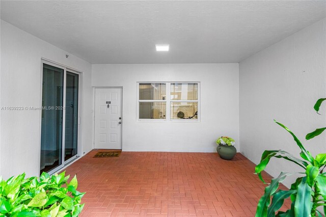 doorway to property with a patio