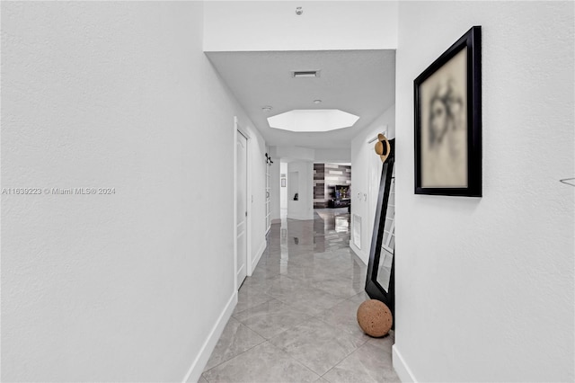 corridor featuring light tile patterned floors