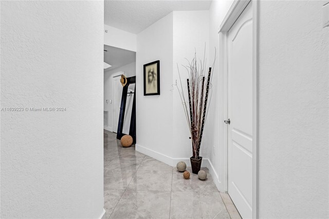 hallway with light tile patterned flooring