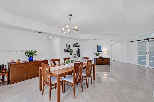 dining area featuring light tile patterned floors, a barn door, and an inviting chandelier