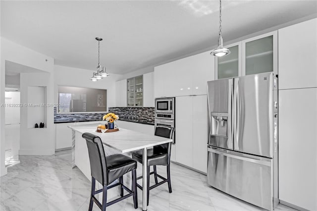 kitchen featuring stainless steel appliances, white cabinets, and glass insert cabinets