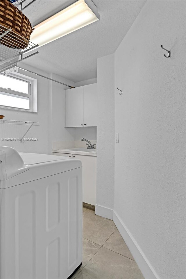 washroom featuring light tile patterned floors and cabinets