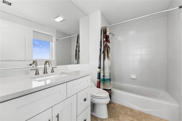 full bathroom featuring tile patterned flooring, vanity, toilet, and shower / tub combo with curtain