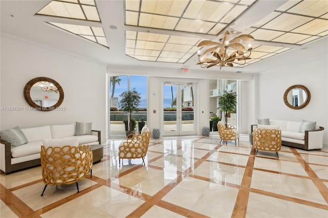 living room featuring ornamental molding and a chandelier