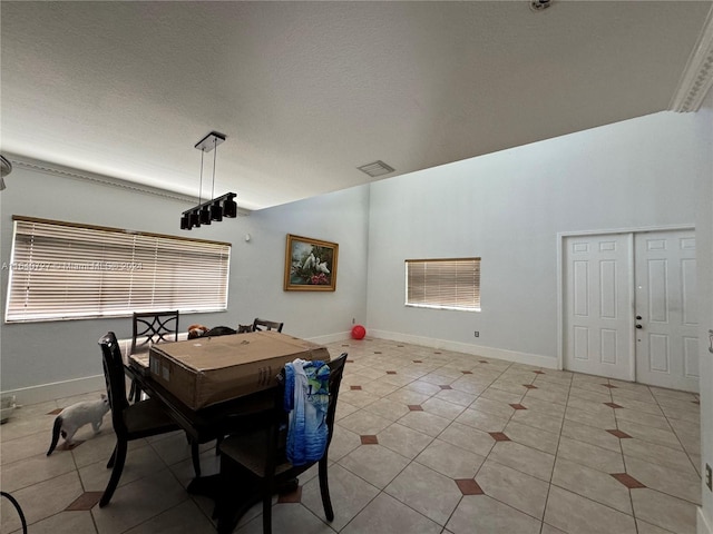 dining area featuring light tile patterned flooring and a textured ceiling