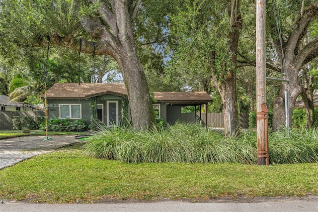 view of front of house with a front lawn and a carport