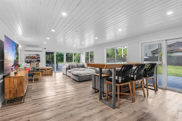 sunroom / solarium featuring wood ceiling and a wall unit AC