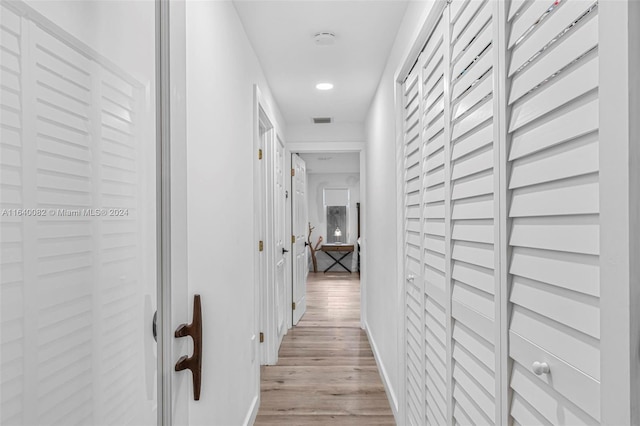 corridor with light hardwood / wood-style flooring