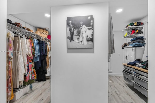 walk in closet with light wood-type flooring