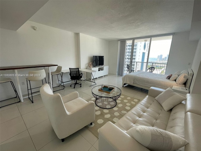 tiled living area featuring a textured ceiling