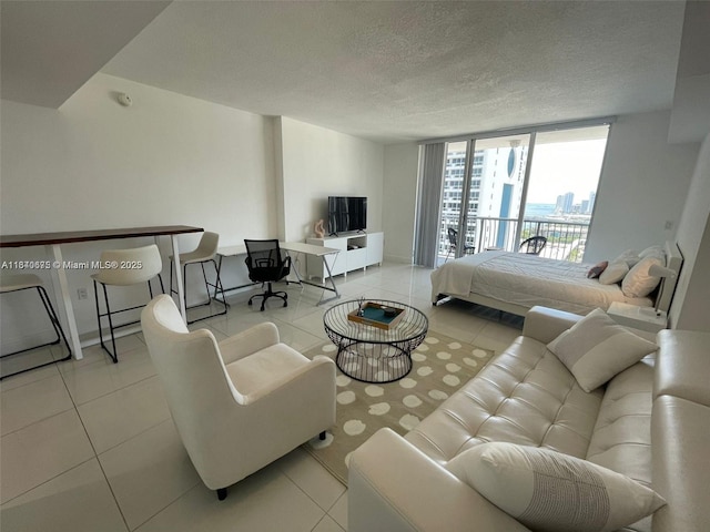 1750 N Bayshore Dr Unit 2708, Miami, FL 33132 - bedroom with tile patterned floors, a textured ceiling, expansive windows, and baseboards