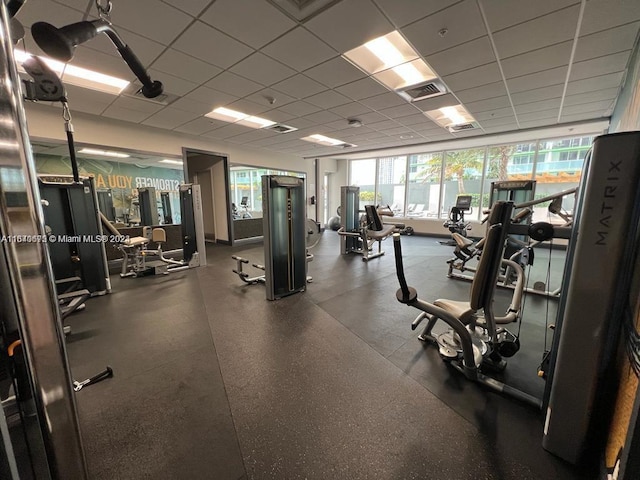 workout area featuring visible vents and a paneled ceiling