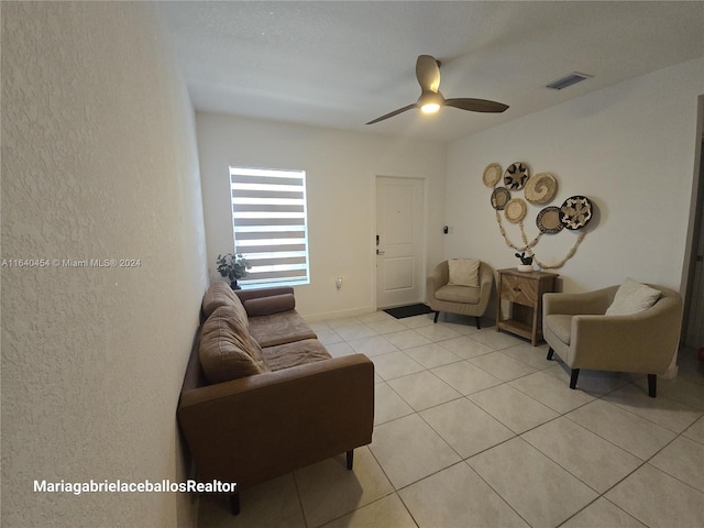 tiled living room featuring ceiling fan