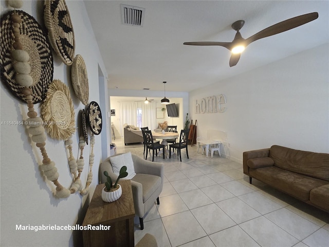 tiled living room featuring ceiling fan