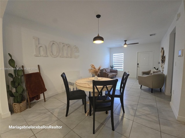 dining space featuring ceiling fan and light tile patterned floors