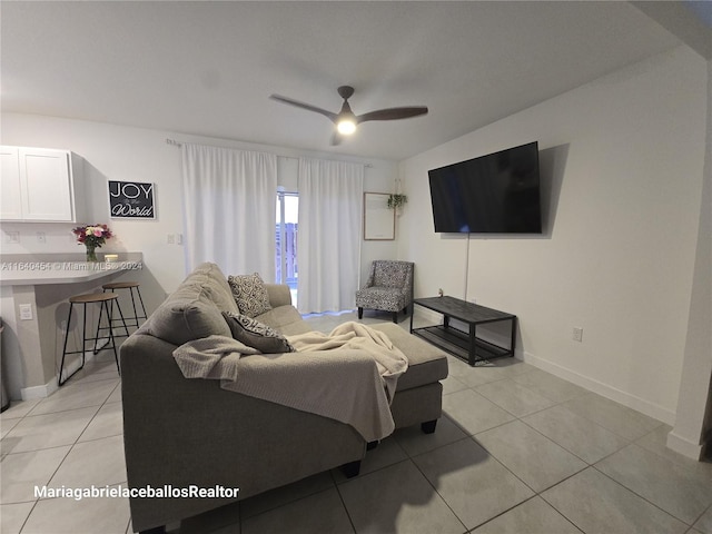 tiled living room featuring ceiling fan