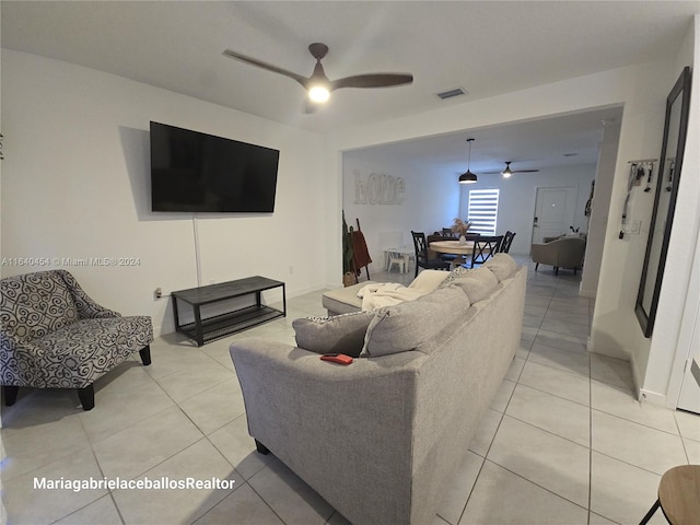 living room with light tile patterned floors and ceiling fan