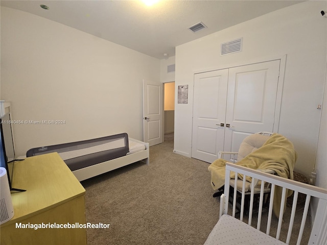 carpeted bedroom with a closet