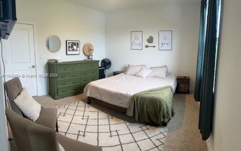 bedroom with light colored carpet