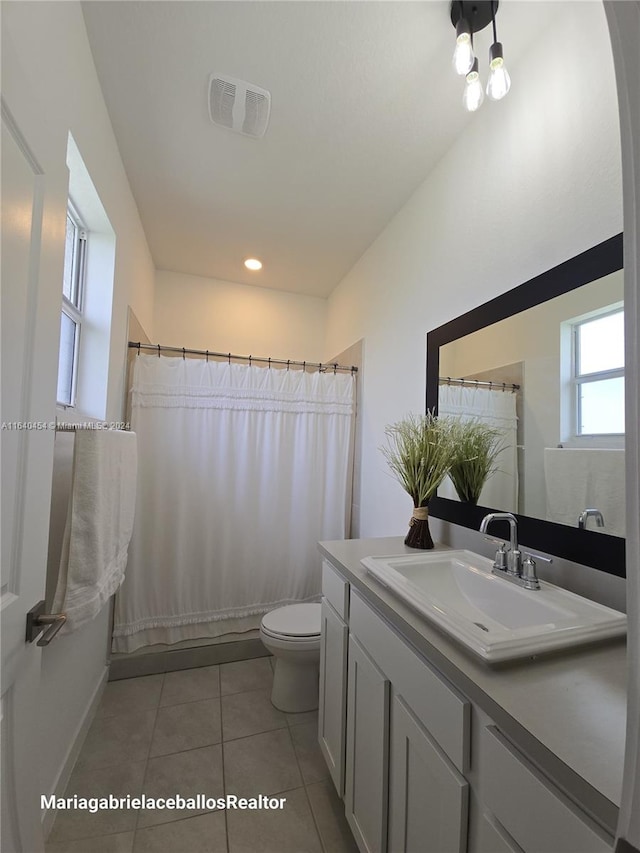 bathroom featuring tile patterned floors, vanity, and toilet