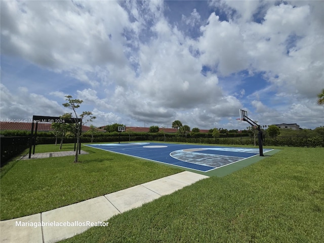 view of sport court with a yard