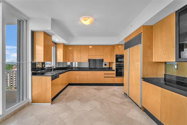 kitchen featuring black oven, dishwasher, sink, and paneled refrigerator