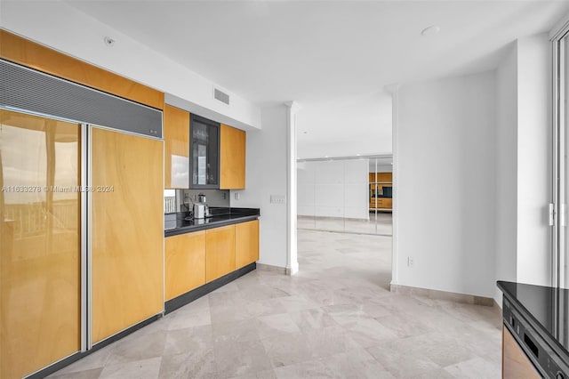 kitchen with paneled built in refrigerator