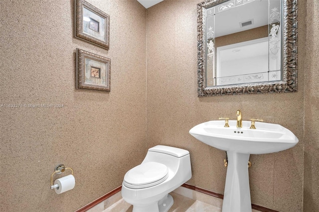 bathroom featuring tile patterned flooring and toilet