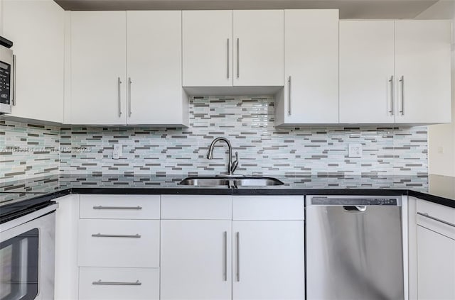 kitchen featuring stainless steel appliances, white cabinetry, sink, and decorative backsplash