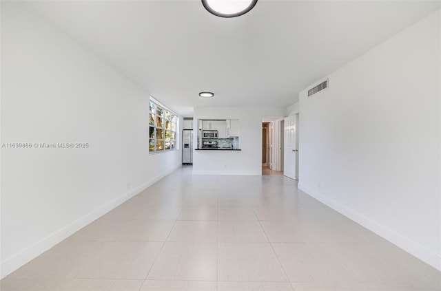 unfurnished living room featuring light tile patterned floors