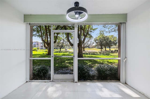 entryway with a healthy amount of sunlight and light tile patterned floors