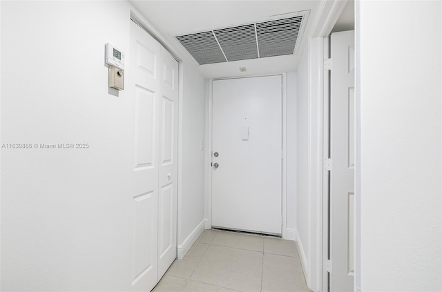 corridor with light tile patterned floors