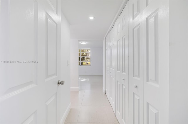 hall featuring light tile patterned floors