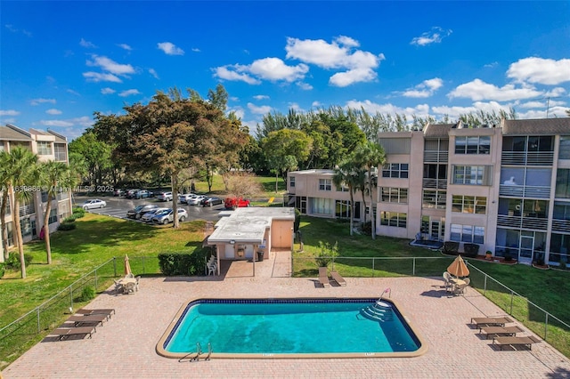 view of swimming pool featuring a lawn and a patio area