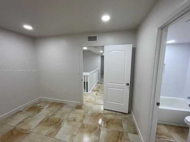 bathroom featuring tile patterned floors, bathtub / shower combination, and toilet