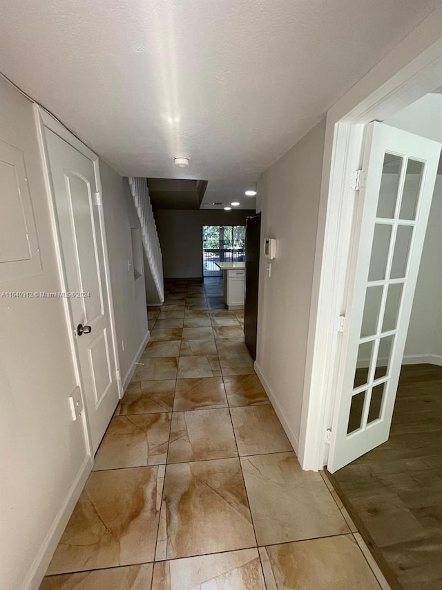 corridor featuring light tile patterned floors