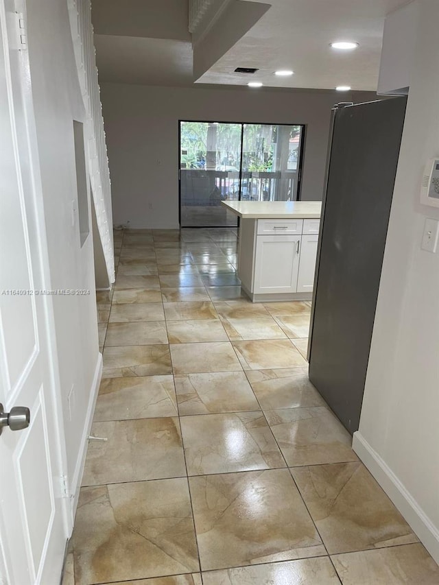 hallway featuring light tile patterned floors