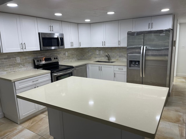 kitchen featuring tasteful backsplash, stainless steel appliances, light tile patterned floors, and white cabinetry