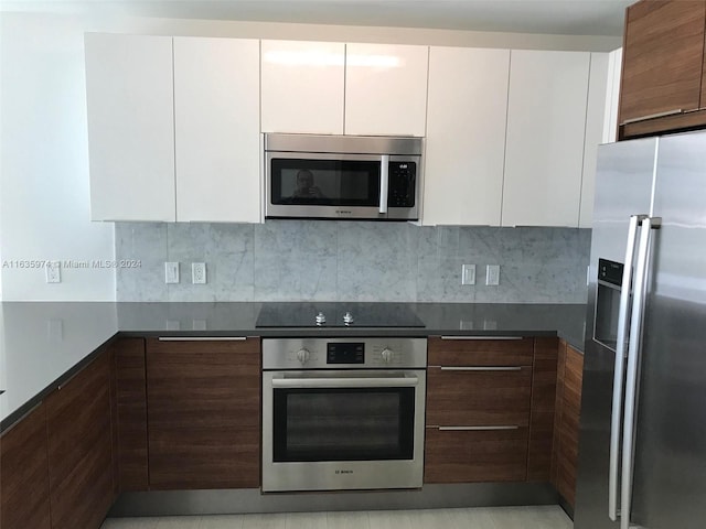 kitchen with white cabinetry, appliances with stainless steel finishes, and tasteful backsplash