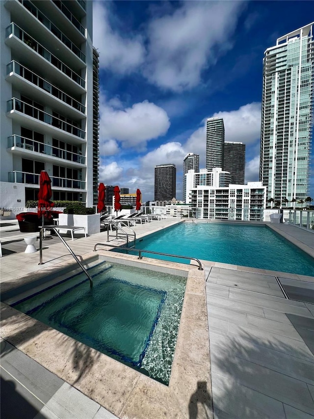 601 NE 27th St Unit 1206, Miami, FL 33137 - community pool featuring a community hot tub, a city view, and a patio area