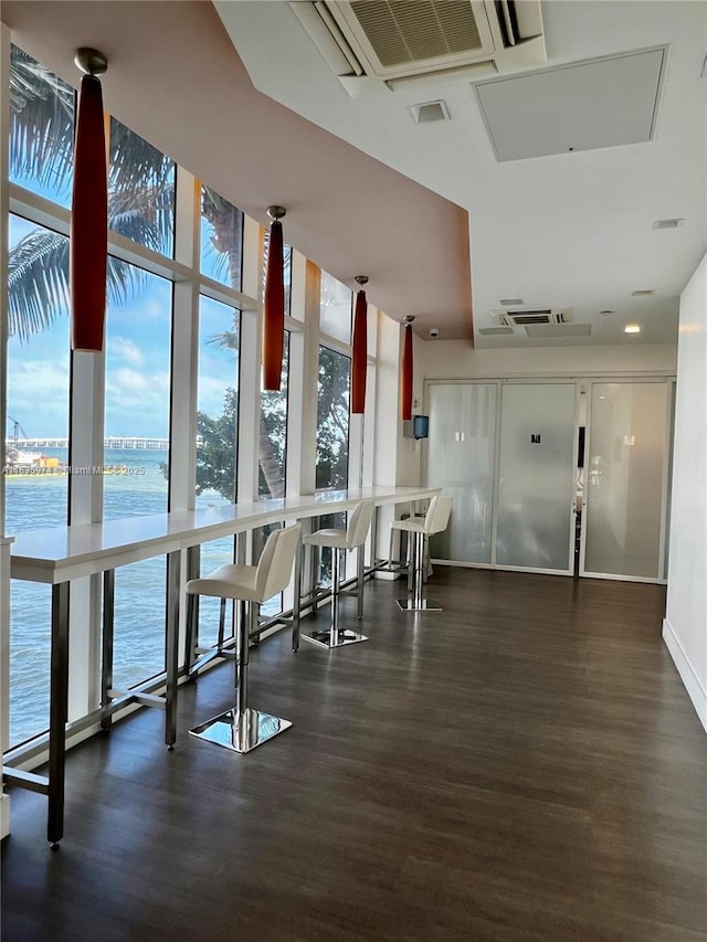 601 NE 27th St Unit 1206, Miami, FL 33137 - dining space with a wall of windows, wood finished floors, and a water view