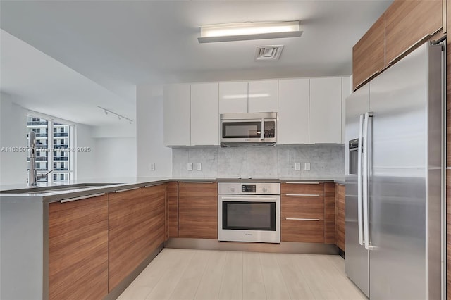 601 NE 27th St Unit 1206, Miami, FL 33137 - kitchen featuring appliances with stainless steel finishes, modern cabinets, and brown cabinets
