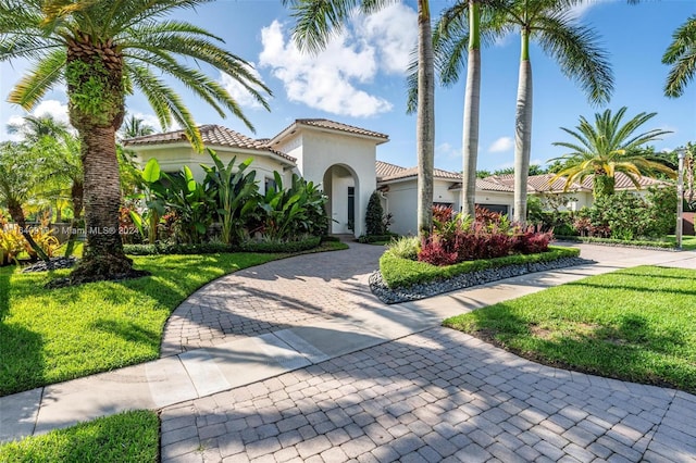 mediterranean / spanish-style home with a front yard