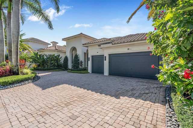 mediterranean / spanish home featuring a garage