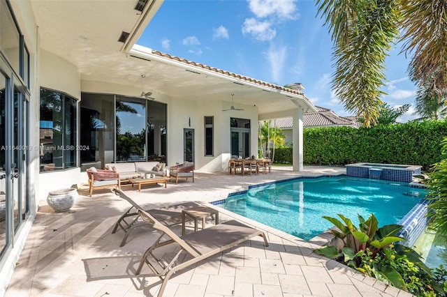 view of swimming pool with ceiling fan, a patio area, outdoor lounge area, and an in ground hot tub