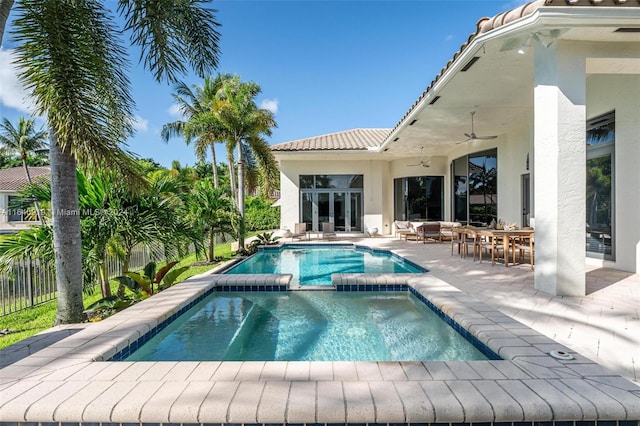 view of swimming pool featuring ceiling fan and a patio area