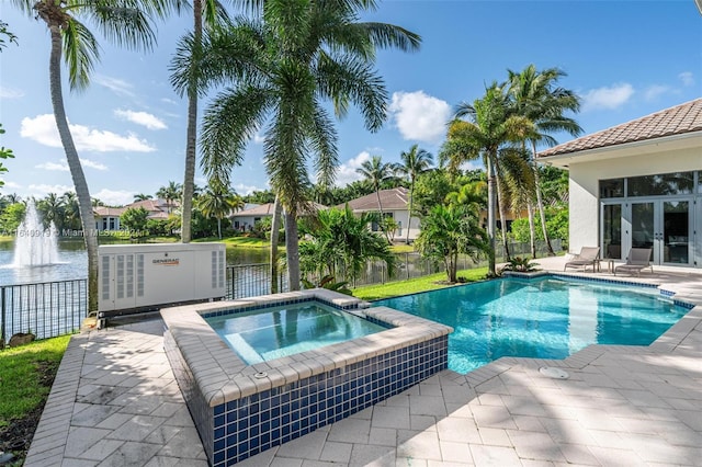 view of swimming pool with a patio and an in ground hot tub